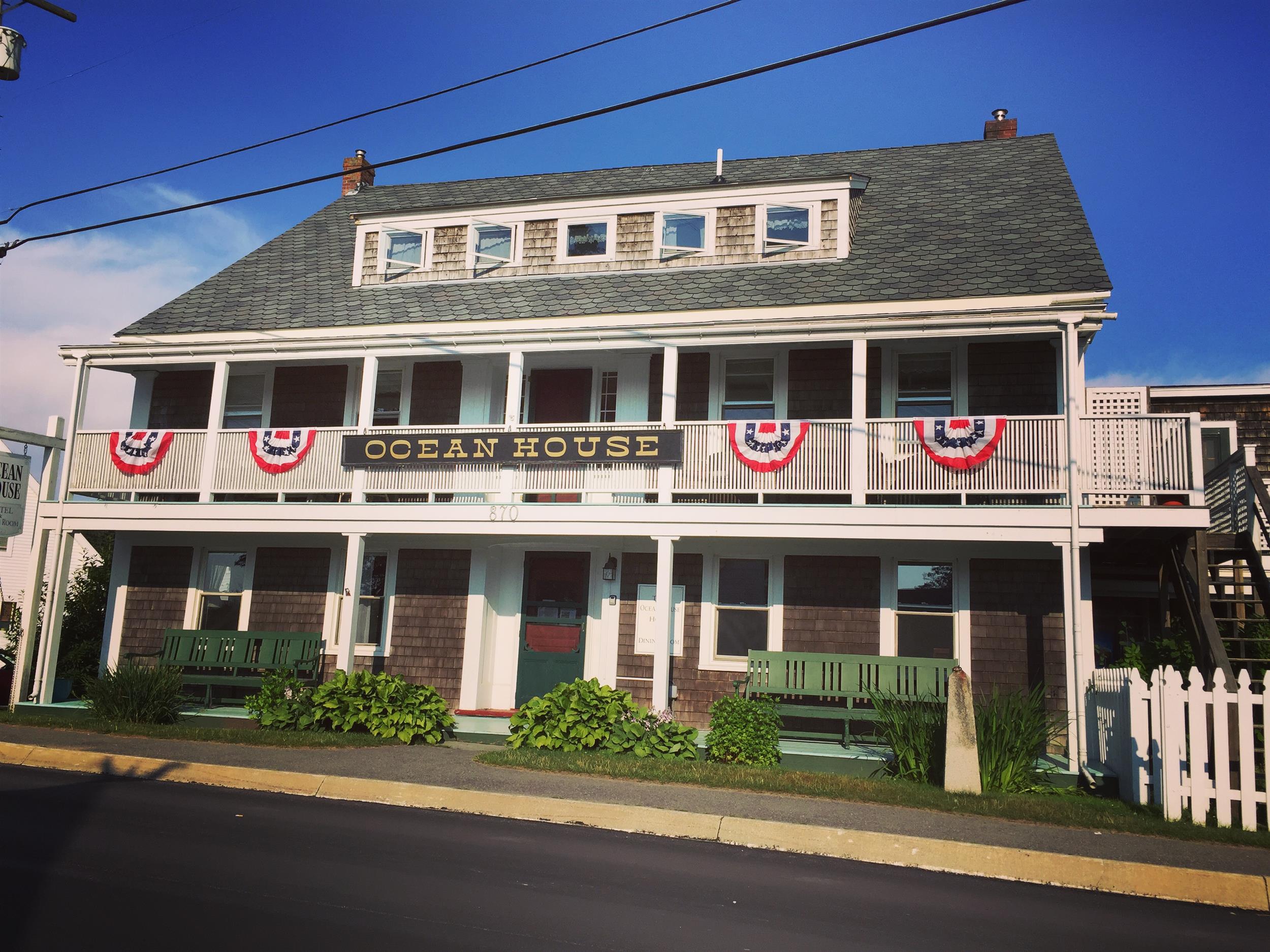 Cedar shake hotel with white porch, street view
